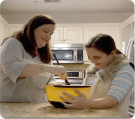 patient Alison cooking with young girl