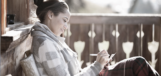 actor portrayal of woman writing in a notebook